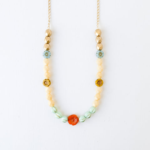 Elegant Cream and Gold Beaded Necklace with Floral Accent